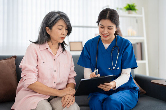 Professional doctor consulting senior patient at home . medical care visit. talking providing medical assistance. Elderly people home care concept.
