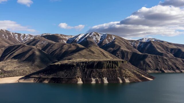 View of Lucky Peak Lake and surrounding mountains under a cloudy sky in Ada County, Idaho, United States.