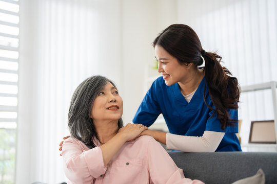 Female  doctor provide emotional support and encouragement to an elderly woman during a home healthcare consultation.