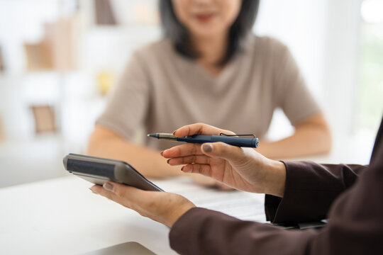Financial advisors, real estate agents, insurance, retirement fund management concepts. Financial advisors present document plans to seniors planning for retirement.