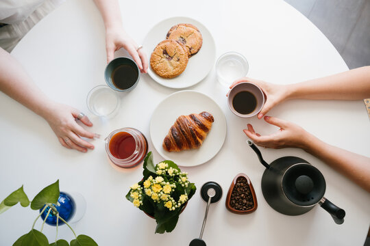 Sharing Fresh Pour Over Coffee and Pastries Together During a Relaxed Breakfast at Home. coffee with friend