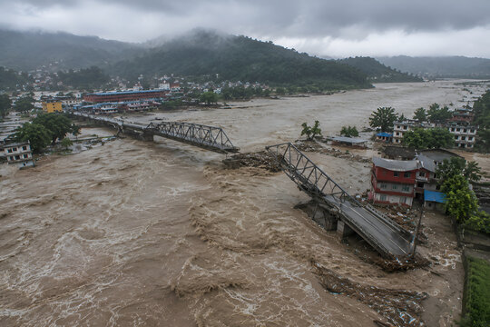 Devastating Nepal Flood with Collapsed Bridge and Raging River in Mountain Valley