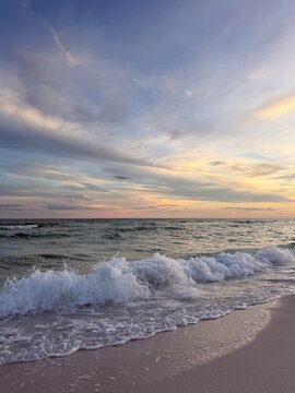 Large crashing wave with soft sunset skies over the Gulf of Mexico Destin, Florida 