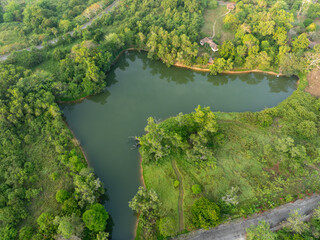 Obraz premium Aerial view of a tranquil freshwater lake surrounded by tropical forest. Natural landscape. Ecology and retreat. Nature, conservation and peaceful countryside. Ecosystem and sustainable tourism.