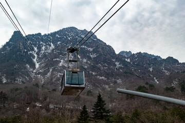 Cable car over snowy mountain slope © Ruslan Bolgov