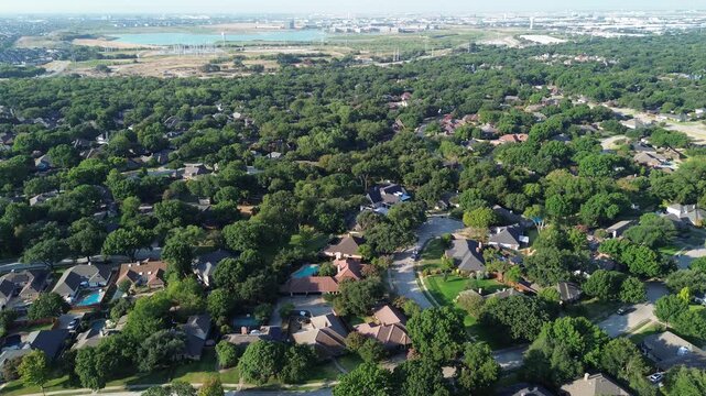 Distant water basins shimmer beyond Mockingbird Lane corridors in quiet DFW Metroplex enclaves. Verdant forest canopies blanket family properties across scenic Coppell, Texas