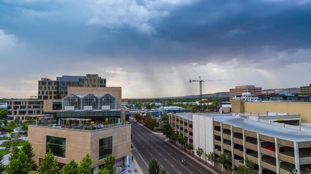 View of a modern building with a rooftop terrace and a parking garage along a street in Boise, Idaho, United States.