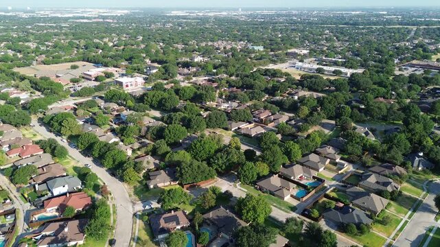Sparkling swimming pools dot private backyards along Belt Line Road zones in North Texas. Sprawling tree lines border attractive single family homes across Coppell, Texas