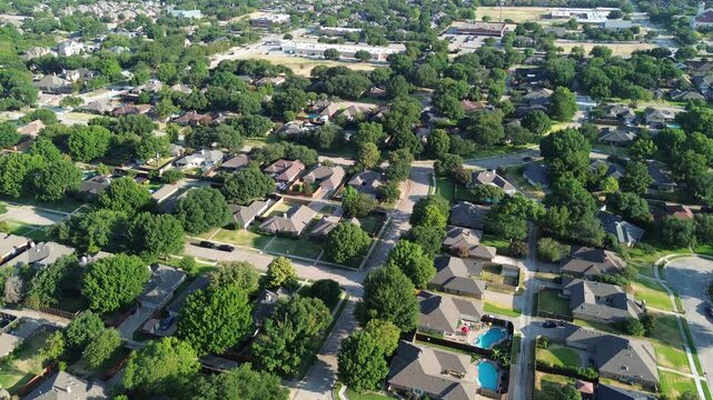 Curving concrete streets intersect along Mockingbird Lane across Northwest Dallas County. Shaded front lawns border single family properties throughout scenic Coppell, Texas