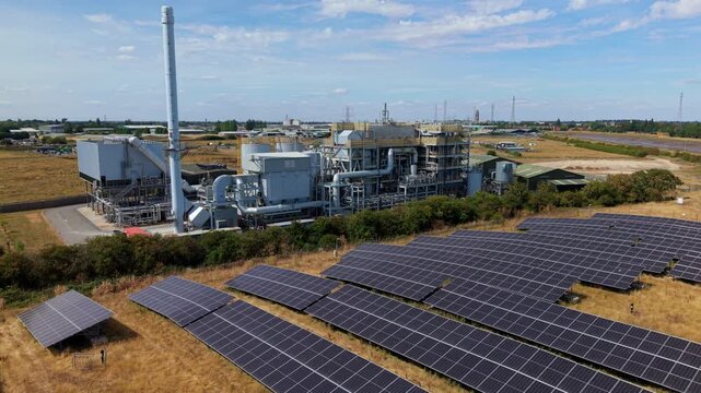 Close up aerial view of industrial energy recovery facility and surrounding solar panel arrays Lincolnshire UK