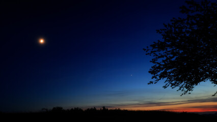Moon, planet conjunction and landscape scenery silhouettes. © astrosystem