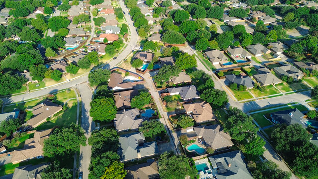 Deep blue pools accent secluded rear patios along Mockingbird Lane cul de sacs in Northwest Dallas County. Shady oak groves enclose detached suburban dwellings across Coppell, Texas