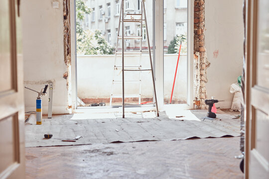 Workers changing old windows and doors in the appartment.