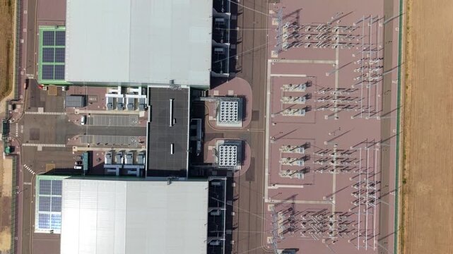 Close-up aerial view of massive rooftop cooling fan banks and HVDC converter halls at Viking Link interconnector station in Bicker Fen, Lincolnshire, UK