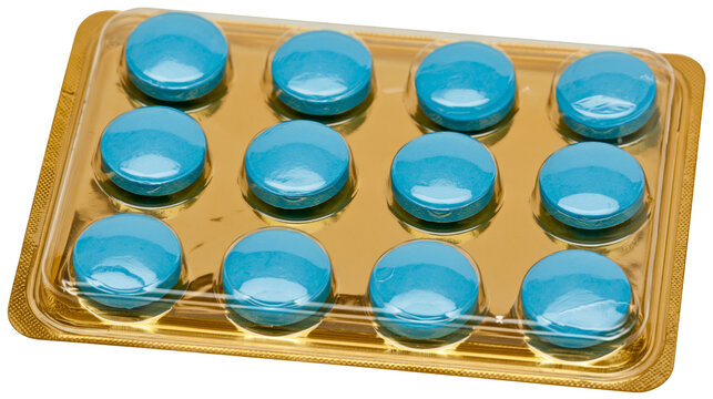 Twelve round blue pills in a golden blister pack, isolated on transparent background