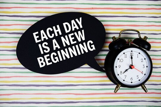 Each day is a new beginning text on speech bubble with alarm clock on colorful stripes background