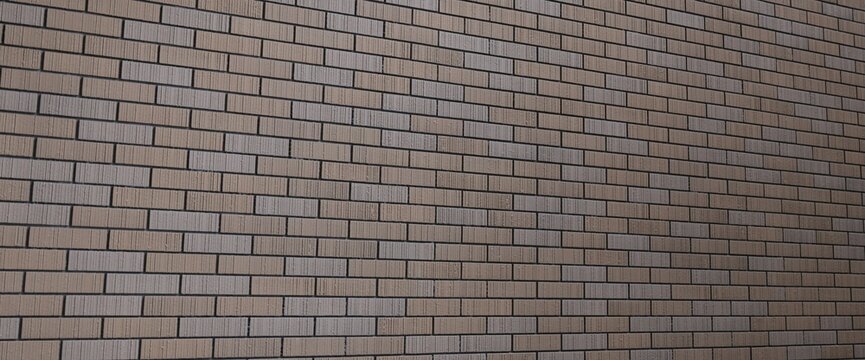Beige brick wall texture with narrow rectangular bricks fine vertical surface lines dark mortar joints horizontal masonry pattern subtle perspective neutral architectural background wall surface