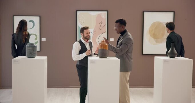 Men, talking and exhibition with sculpture at gallery with negotiation, explain and smile for deal. People, curator and customer with art shopping, happy and display with culture, talent or vase
