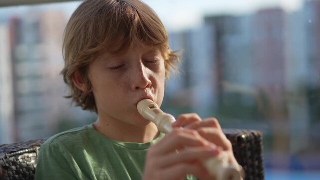 A little boy learns to play the flute at home, practicing with focus and enthusiasm in a cozy, warm setting. A charming scene of early musical exploration, creativity, and childhood growth.
