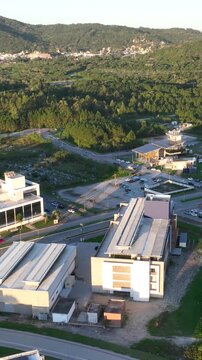 Artificial Lake Integrated with Modern Technology Buildings and Green Infrastructure in Florian&oacute;polis, Brazil. Establishing Shot. Aerial View.