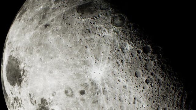 The moon is visible in the night sky. Craters and surface features are clearly seen. The background is black with no other objects. This is a close up view of the moons surface.