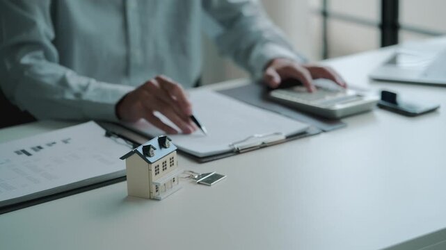 financial advisor evaluates house valuation and mortgage loan in an office