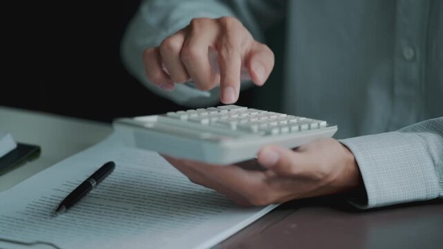 Accountant calculating numbers in office with documents for valuation accuracy
