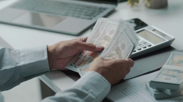 Close up hands counting dollar bills, business finance and economy concept