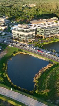 Artificial Lake Integrated with Sustainable Infrastructure, Modern Buildings and Preserved Green Landscape in Florian&oacute;polis, Brazil. Establishing Shot. Aerial View.