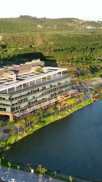 Artificial Lake Integrated with Sustainable Infrastructure, Modern Buildings and Preserved Green Landscape in Florian&oacute;polis, Brazil. Establishing Shot. Aerial View.