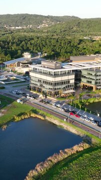 Artificial Lake Integrated with Sustainable Infrastructure, Modern Buildings and Preserved Green Landscape in Florian&oacute;polis, Brazil. Establishing Shot. Aerial View.