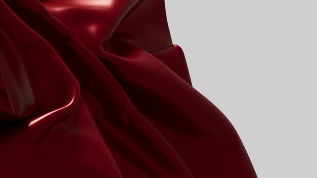 Beautiful shiny maroon material moves slowly creating a soft backdrop
