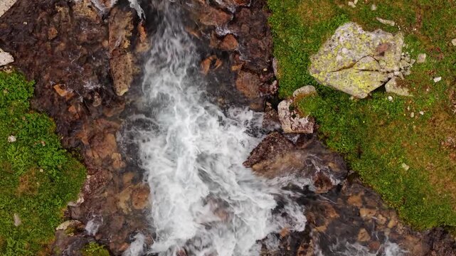 Aerial view of fast flowing mountain stream rapids