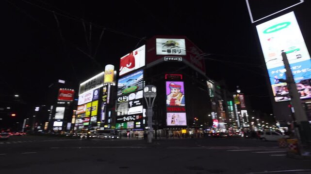 Sapporo, Hokkaido, Japan - 19 August 2026: View of the illuminated Susukino district at night with bright neon signs and busy city streets.