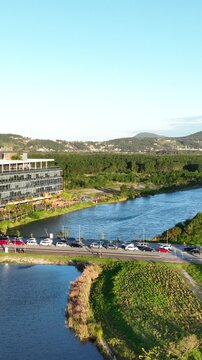 Artificial Lake Integrated with Sustainable Infrastructure, Modern Buildings and Preserved Green Landscape in Florian&oacute;polis, Brazil. Establishing Shot. Aerial View.