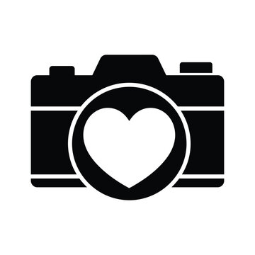 Black and white icon of a camera with a heart lens in a minimalist silhouette
