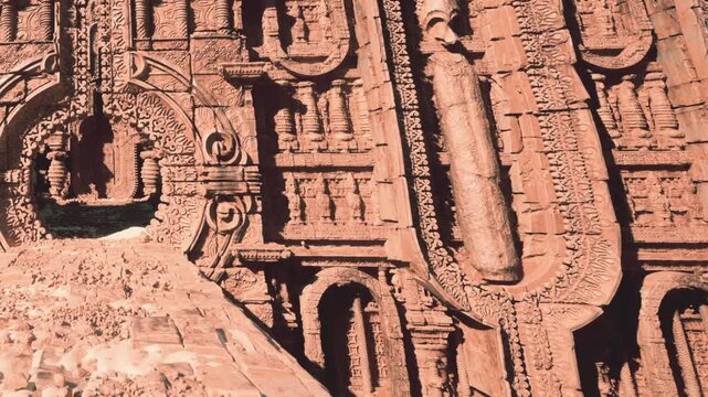 Visitors explore intricate carvings on the walls of an ancient temple in a historical site. The sun illuminates the designs, highlighting the craftsmanship and details.