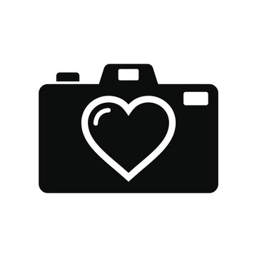 A camera icon featuring a heart shape in a minimalist black and white silhouette