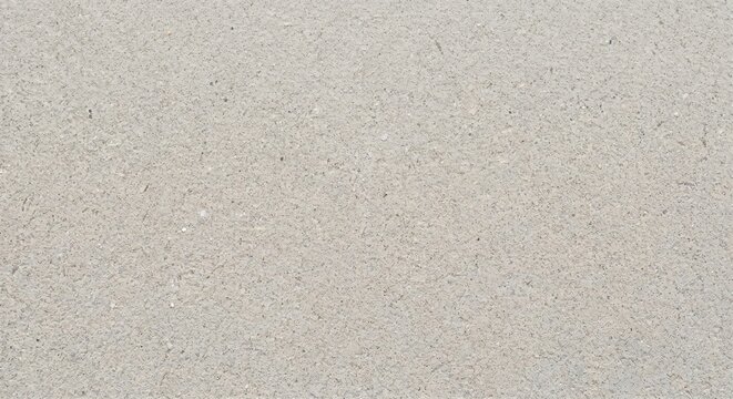 Light beige speckled sand texture and grainy abstract background pattern with grainy surface