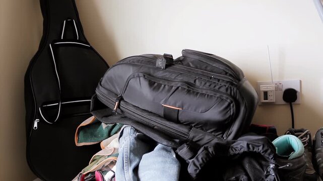 Cluttered Room With Backpack, Clothes, And Guitar Case Indoors - 4K