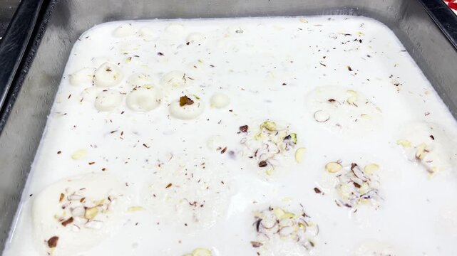 Metal Baking Pan Filled With Traditional Bengali Sweets And Creamy Rasmalai Clay Pots