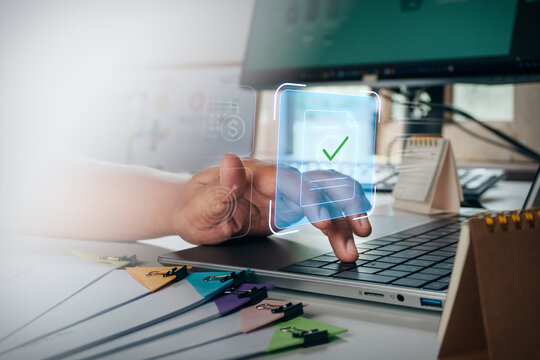 Business professional typing on laptop keyboard with digital hologram interface of document approval and verification, concept of electronic workflow, paperless office, and digital business management