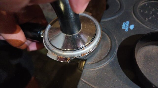 Grinding fresh coffee beans.