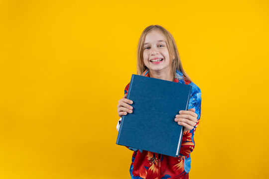 Cheerful Girl Showing Blank Blue Book Cover to Camera Mockup Concept
