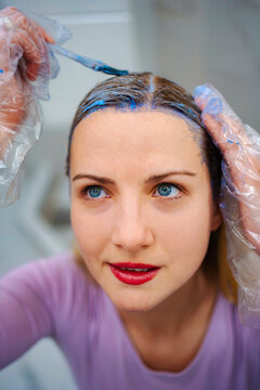 Woman dyeing hair blue for beauty makeover