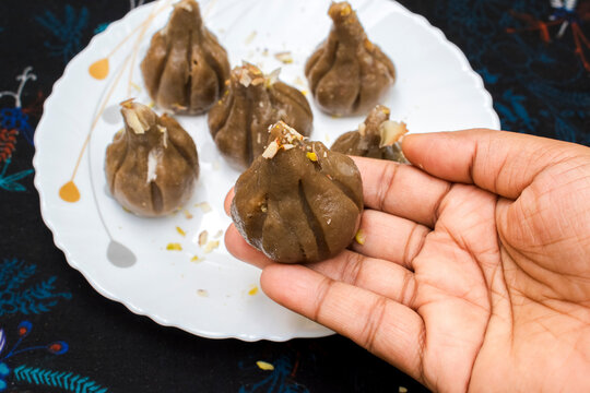 Serving modal in hand for prasad