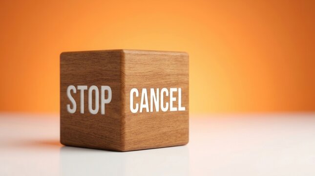Stop Cancel Wooden Cube With Words On Orange Background