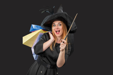 Woman dressed as a witch expressing surprise and joy while holding a magic wand and multiple colorful shopping bags, embodying the thrill of festive shopping © somemeans