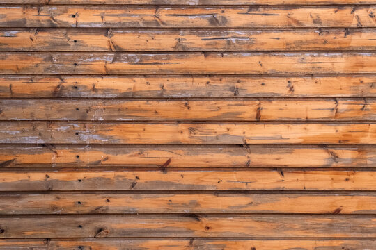 Wooden planks forming a rustic and aged horizontal surface, offering a natural texture and pattern suitable for various background applications