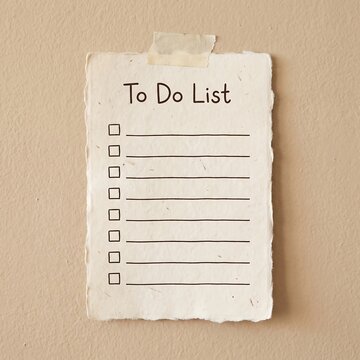 Blank To Do List on textured paper taped to a wall for planning and task management